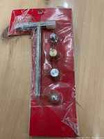 Photo of four craft hammers sealed in original plastic packaging with red cardboard backing