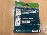 Front photo of sealed package of electric outlet and wall plate insulators showing brand and product function.
