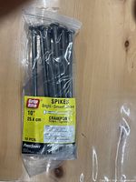 Clear plastic package containing 10 Grip Rite brand bright smooth shank metal spikes, 10 inches long, labeled with product specifications.