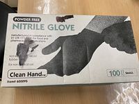 Photo of box showing 'Clean Hand' brand nitrile gloves, powder free, small size, 100 count.