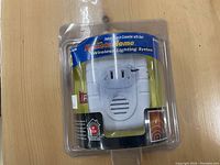 White RemoteHome Wireless Lighting System device for indoor use with alert feature, packaged in blister pack.