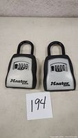 Front view of two Master Lock portable lock boxes showing combination dials and branding.