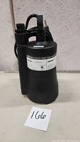 Front view of black Mastercraft submersible utility pump showing label with product info.