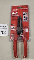 Front view of Milwaukee 6 in 1 Combination Pliers in sealed blister packaging showing model number and wire stripping capacity