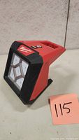 Front angle view of Milwaukee M12 Compact LED Floodlight showing 4 LEDs, brand logo, and overall shape.