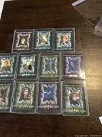 Photo showing 11 protective sleeved collectible cards with decorative silver starburst borders featuring various Harry Potter characters from the Prisoner of Azkaban set.