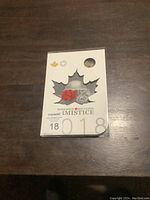 Closed display folder featuring a maple leaf cutout and thematic design for the 2018 Canadian Armistice commemorative coins.