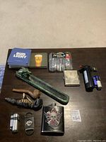 Overview of all items including pipes, flask, lighters, cutters, coasters and plastic cups