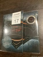 Sealed packaging with Batman v Superman logo and visible 3D coin window.