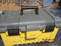 Closed large yellow and black Stanley tool box showing top handle, black latches, and Stanley brand mark.