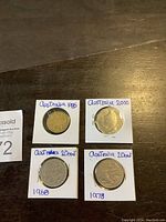 Four Australian 20 cent coins from 1968, 1978, 1988, and 2000 displayed in cardboard flips with year labels.