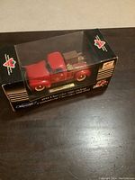 Side view of the MIB 1952 Chevrolet 3100 pickup model in original Canadian Tire box with sled and snowshoes.