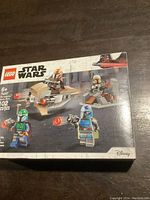 Front of Lego Star Wars box showing Mandalorian minifigures and battle vehicles, set number 75267, 102 pieces, age 6+