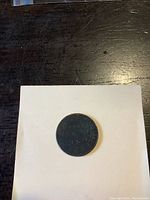 Top view of the coin, showing the reverse side with the text and date.