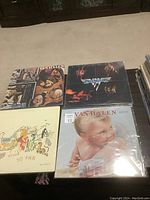 Four LP albums displayed: three Van Halen albums and one Stills Nash Young album, all with plastic protective covers.