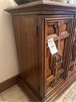 Front view showing left front door with decorative raised panels and brass-tone handle