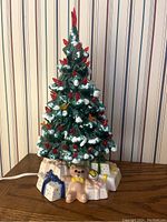 Front view of the ceramic Christmas tree with base of presents and teddy bear figurine