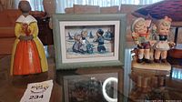 Dutch shadow box art framed with green rustic frame, depicting children in traditional Dutch clothes near sailboats