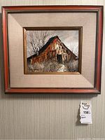 Full view of oil painting of barn in wood frame with red accents on wall