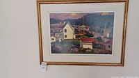 Front view of framed acrylic painting showing stylized houses and hills