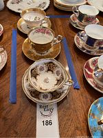 Group shot of six bone china teacup and saucer sets within marked area