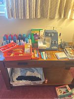 overview of sewing machine on table with thread spools and accessories