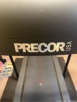 Close-up of Precor USA logo on console