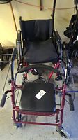 Foldable Quickie manual wheelchair with black seat and backrest shown from front.