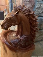 Close-up three-quarter view of carved horse head and mane detail