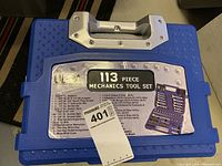 Photo of closed blue blow mold case containing the Ultra 113 piece mechanics tool set, showing label with item details and brand.