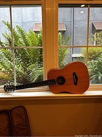 Front view of Baby Taylor BT1 guitar on windowsill