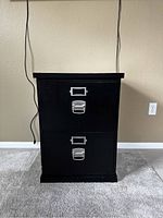 Front view of the black 2-drawer file cabinet showing both drawers and metal handles.