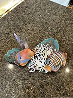 Front view of colorful tropical fish and coral reef sculpture on countertop