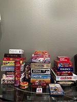 View of entire game lot arranged in three stacks on a glass table, showing titles and boxes