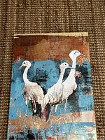 Close-up image showing detailed texture, style, and design of the print depicting three birds with blue and brown abstract background.