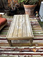 Top-down view showing teak slatted tabletop