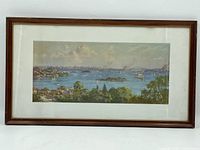 Full front view of framed panorama print leaning against white background