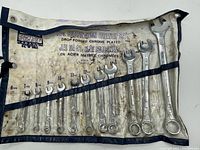 Image of the entire 12 piece metric combination wrench set arranged in the canvas roll-up pouch, showing wrenches from 6mm to 17mm with visible wear and chrome plating.