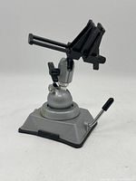 Front and side view of PanaVise suction base vise showing the adjustable clamp and lever mechanism.