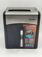 Front view of STAPLES MAILMATE shredder showing the brand logo, compact size, and front transparent window for contents visibility.