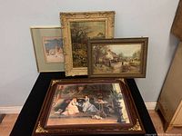 Photo showing all four framed prints grouped together displaying varying artwork and frame styles.