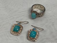 Photo of ring and earrings showing silver filigree and blue stones
