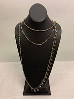 Full view of the 3-strand necklace displayed on black bust, showing arrangement of silver and beaded strands.