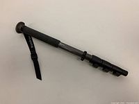 Full view of the carbon fiber monopod with foam grip and Manfrotto branded strap.