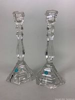 Pair of clear crystal Tiffany & Co. candleholders with original tags, showing overall shape and size.