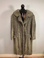 Full front view of vintage Persian lamb fur coat on a display mannequin.