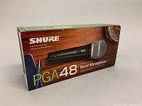 Box for Shure PGA48 vocal microphone showing branding and model.