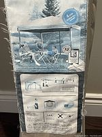 Packaging showing a depiction of the taupe-colored gazebo with four screen walls and metal frame, highlighting that it assembles in minutes and protects against UV rays.