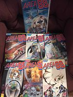 Photo of all 7 AREA 88 comic books fanned out showing diverse cover artwork and titles