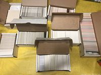 Eight open boxes filled with a large quantity of hockey cards stacked and organized inside